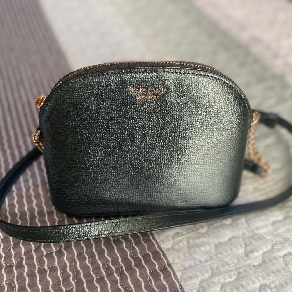 kate spade  iridescent green purse with gold chain hardware.